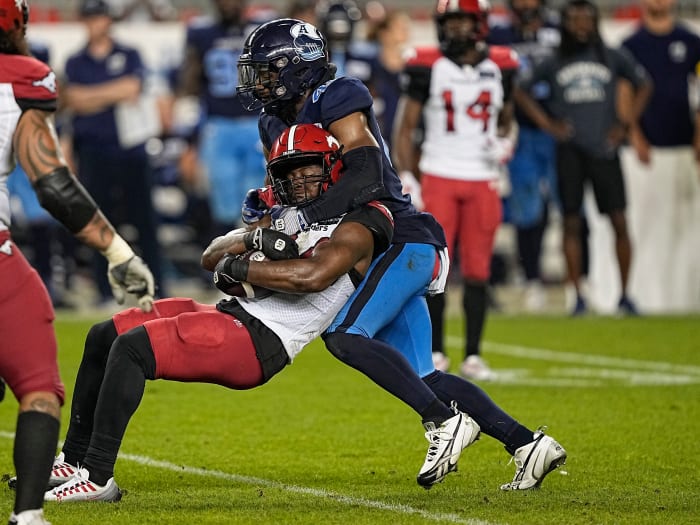 Aug 20, 2022; Toronto, Ontario, CAN; Toronto Argonauts linebacker Wynton McManis (48) tackles Calgary Stampeders running back Dedrick Mills (34) during the second half at BMO Field. Mandatory Credit: John E. Sokolowski-USA TODAY Sports